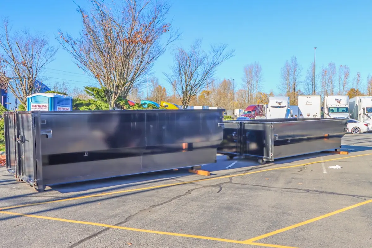 Professional dumpster rental service with roll-off container on residential driveway in Keansburg